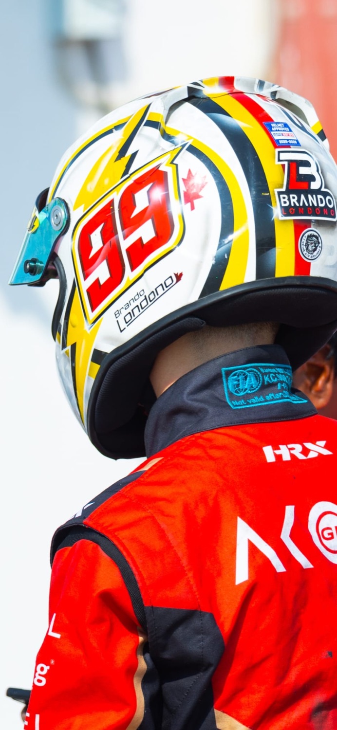 Brando Londoño — #99 race helmet and HRX racing suit